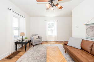 Living area featuring ceiling fan and light wood-style flooring