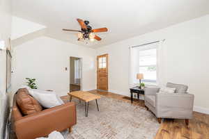 Living room with ceiling fan and wood finished floors