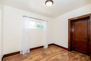Empty room featuring baseboards and light wood-style floors