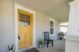 Property entrance featuring stucco siding