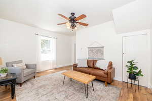 Living room with a ceiling fan and light wood-style flooring