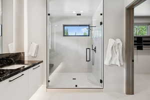 Bathroom featuring vanity, a stall shower, and recessed lighting