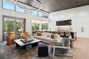Living room featuring a high ceiling and wood finished floors