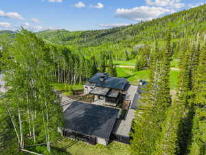 View of subject property featuring a forest and a mountain backdrop