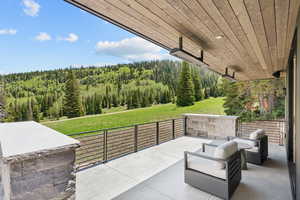 View of patio / terrace featuring a view of trees