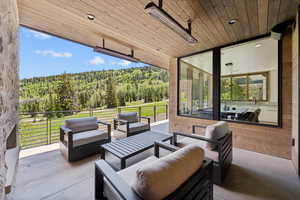 View of patio / terrace featuring a forest view and an outdoor hangout area