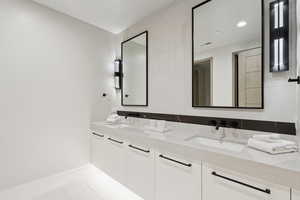 Full bathroom with double vanity and tile patterned floors