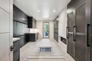 Kitchen with light countertops, recessed lighting, a heating unit, modern cabinets, and light tile patterned floors