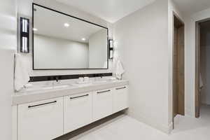 Bathroom featuring double vanity and recessed lighting