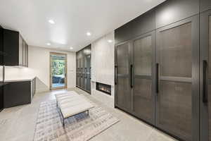Living area featuring recessed lighting, a fireplace, light tile patterned floors, and french doors