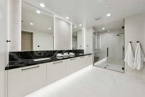 Full bathroom with double vanity, recessed lighting, a shower stall, and tile patterned floors