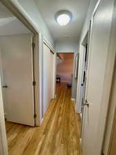 Hallway featuring light wood-style flooring