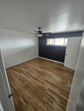Spare room with wood-type flooring and a ceiling fan