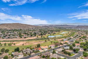 Aerial perspective of suburban area with a water and mountain view and a golf course