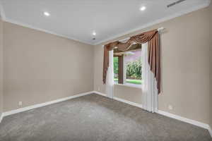 Carpeted spare room with crown molding and recessed lighting