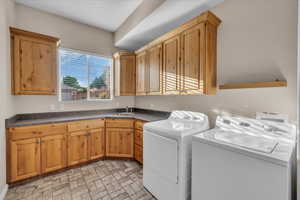 Washroom featuring cabinet space and washer and dryer