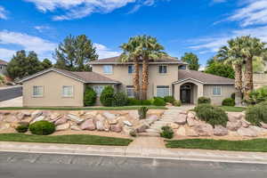 View of front of house featuring stucco siding and a tiled roof