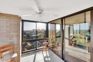 Sunroom / solarium with tile patterned flooring and expansive windows
