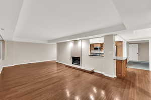 Unfurnished living room with a fireplace, wood finished floors, and recessed lighting