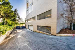 View of side of property featuring asphalt driveway and an attached garage