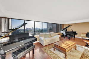 Living area with wood finished floors and baseboards