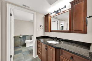 Bathroom featuring vanity, tile walls, and light tile patterned floors