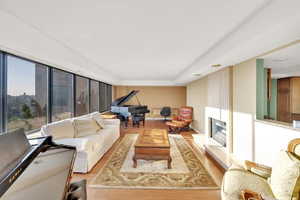 Living room featuring wood finished floors and a large fireplace
