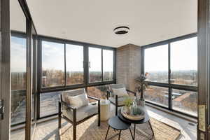 Sitting room featuring floor to ceiling windows