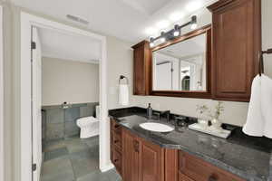 Bathroom with vanity and dark tile patterned floors