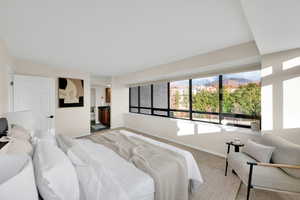 Bedroom featuring ensuite bathroom, carpet, and a mountain view