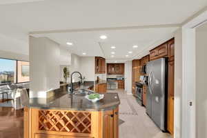 Kitchen with recessed lighting, glass insert cabinets, light tile patterned floors, dark stone countertops, and stainless steel appliances