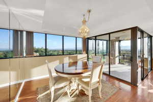 Dining space featuring wood finished floors and a chandelier