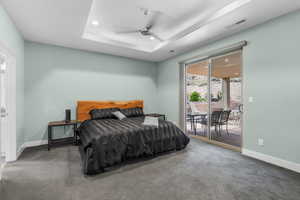 Bedroom featuring access to exterior, recessed lighting, carpet flooring, ceiling fan, and a raised ceiling