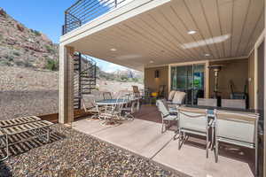 View of patio featuring a mountain view, outdoor dining space, and stairs