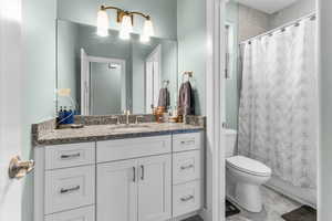 Bathroom featuring vanity and a shower with shower curtain