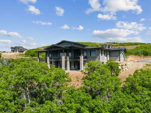 Back of house featuring a balcony