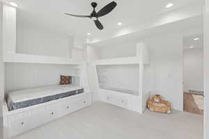 Unfurnished bedroom with recessed lighting, carpet, and a ceiling fan