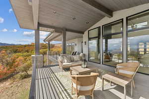 Wooden terrace featuring an outdoor living space