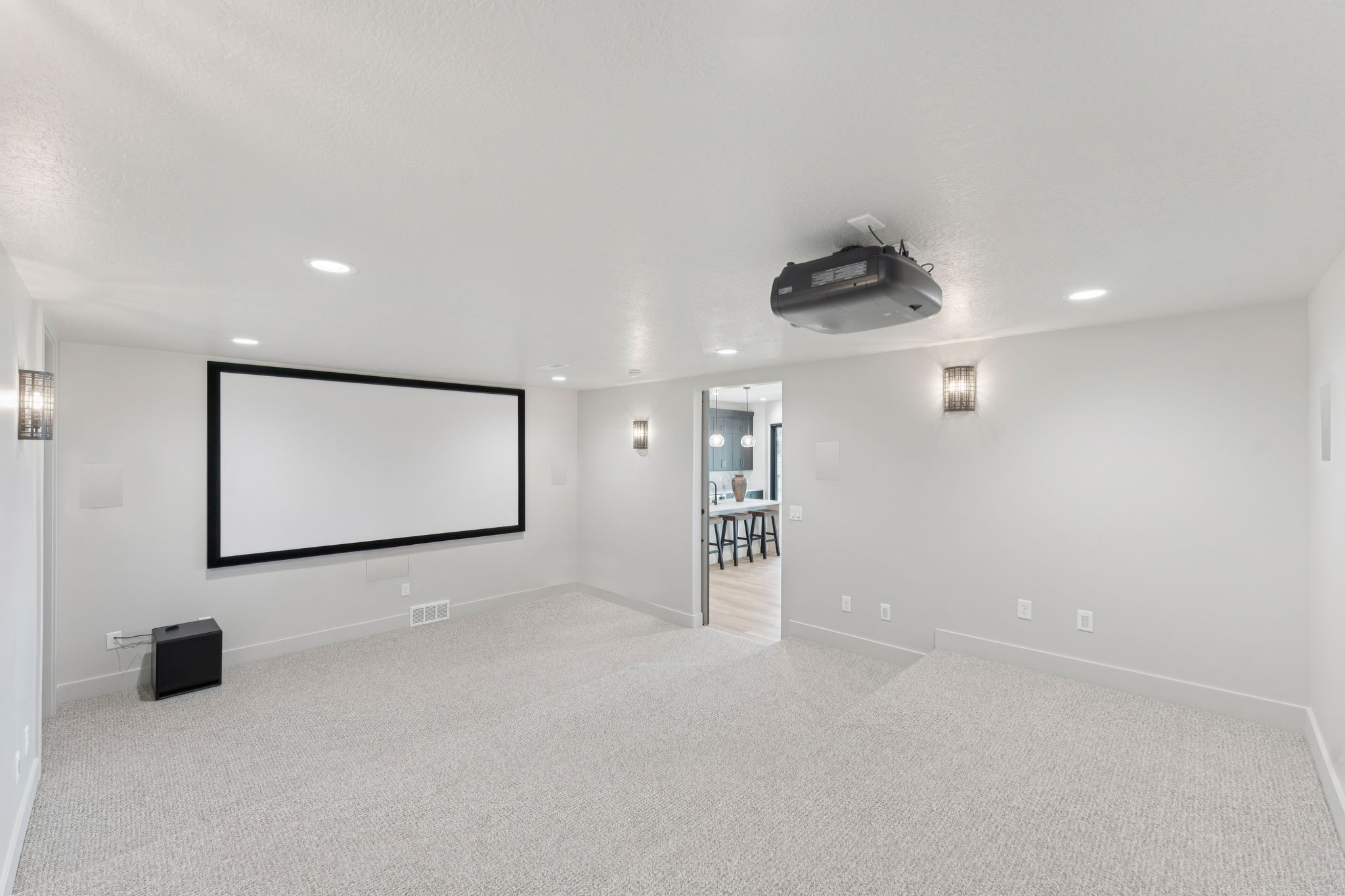 Home theater room with recessed lighting and carpet floors