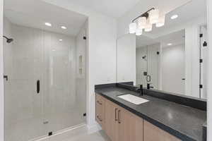 Full bathroom featuring vanity, a stall shower, recessed lighting, and tile patterned flooring