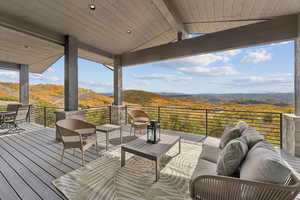 Wooden deck with outdoor lounge area, a mountain view, a patio, and outdoor dining area