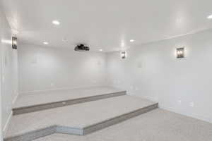 Carpeted spare room with recessed lighting