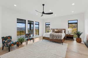 Bedroom featuring a mountain view, recessed lighting, light wood finished floors, and a ceiling fan