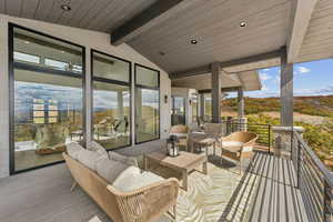 Deck with an outdoor living space and a patio area