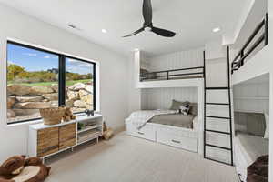 Carpeted bedroom with a ceiling fan and recessed lighting
