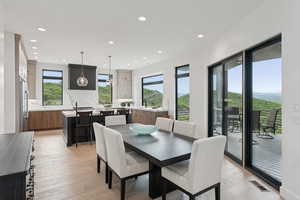 Dining space featuring healthy amount of natural light, recessed lighting, and light wood-style floors