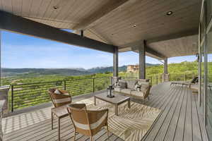 Wooden terrace with a mountain view and an outdoor hangout area