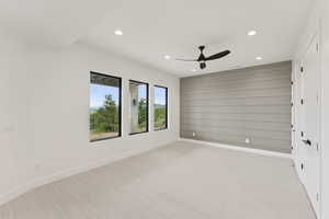 Unfurnished room with recessed lighting, light colored carpet, and a ceiling fan