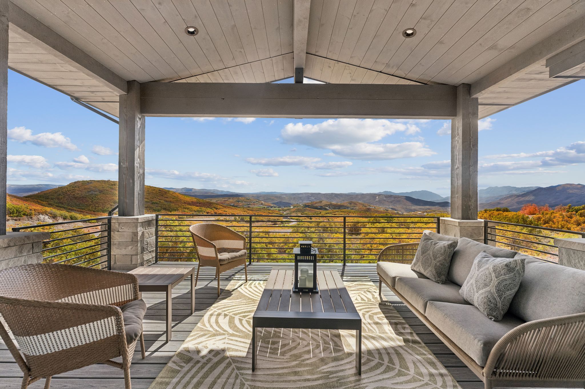 Wooden deck featuring outdoor lounge area, a mountain view, and a patio
