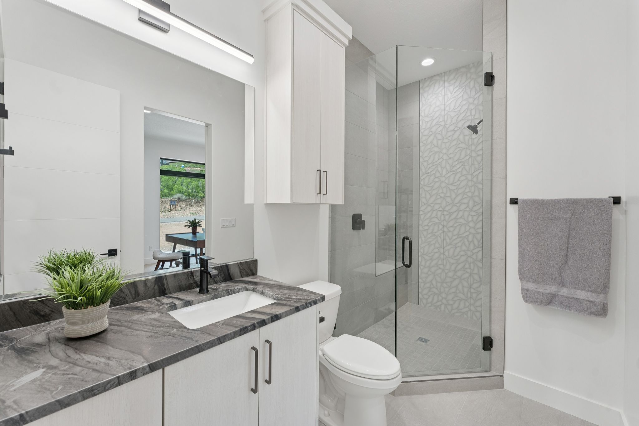 Bathroom featuring vanity, tile patterned flooring, a shower stall, and recessed lighting